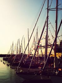 Boats in sea at sunset