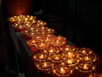 High angle view of illuminated candles on table