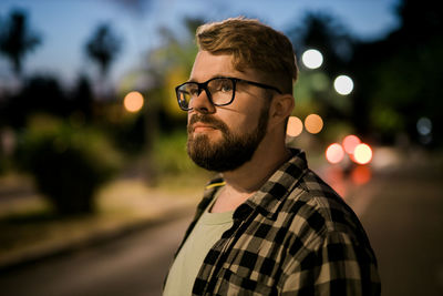 Man standing on street at night