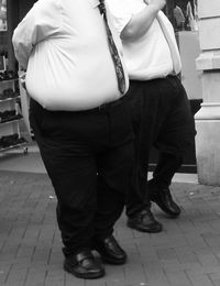 Low section of man standing on footpath