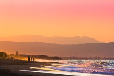 Beach against clear sky during sunset