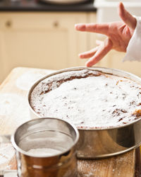 Close-up of hand holding cake