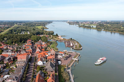 Aerial from the historical village woudrichem with the ferry arriving in the netherlands