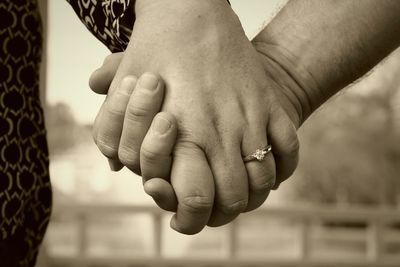 Close-up of couple holding hands