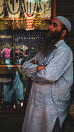 Side view of young man standing outdoors