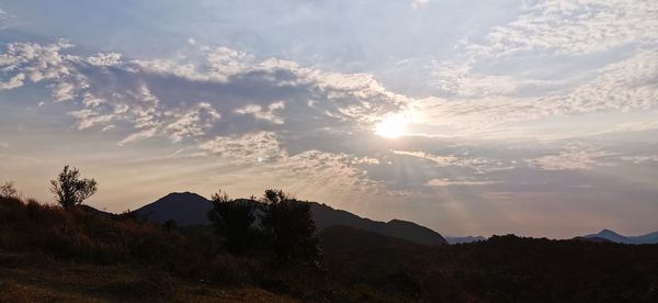 Scenic view of field against sky during sunset