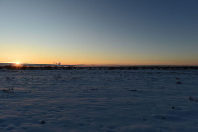 Scenic view of sea against clear sky during sunset