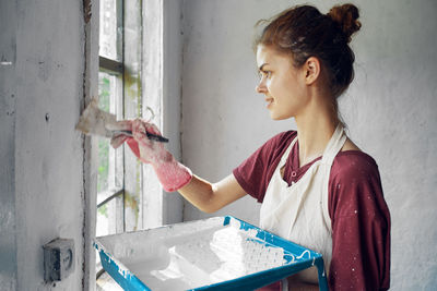 Side view of young woman working at home