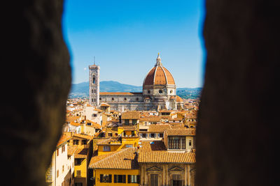 Looking through a hole in the building to santa maria del fiore.