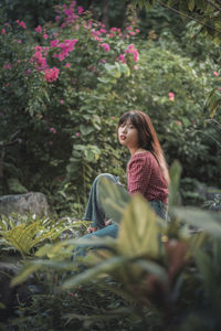 Portrait of young woman sitting on field