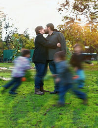 Rear view of couple walking in park