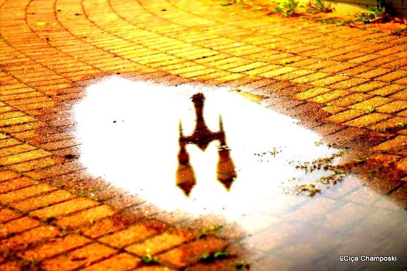 reflection, built structure, cobblestone, architecture, lifestyles, shadow, high angle view, sunlight, wall - building feature, paving stone, walking, footpath, puddle, men, building exterior, steps, street, unrecognizable person