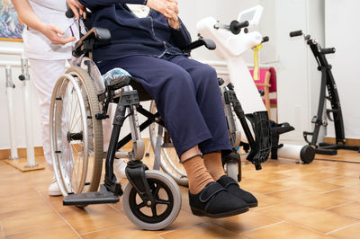 Low section of man sitting on wheelchair