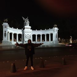 Full length of statue standing at night