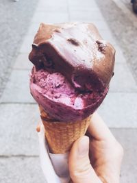 Close-up of hand holding ice cream cone