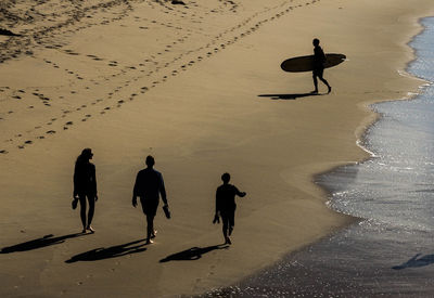 Silhouette people on beach