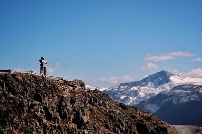 Scenic view of snowcapped mountains against sky and famous whistler inukshuk 