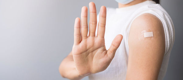 Close-up of hand holding hands over white background
