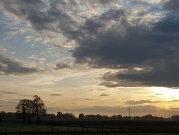 Scenic view of field against sky during sunset