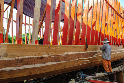 Side view of man working at construction site