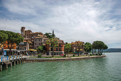 View of the village and shore of lake trasimeno, italy.