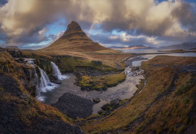 Panoramic view of waterfall against sky during sunset