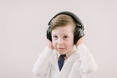 Child in labcoat with headphones