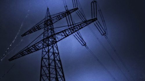 Low angle view of power lines against sky