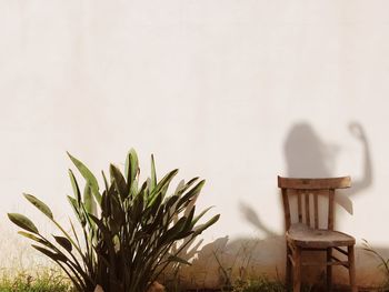 Empty chairs and table against wall at home