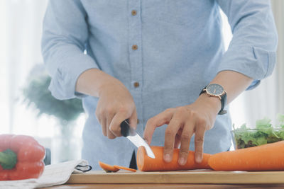 Midsection of man preparing food