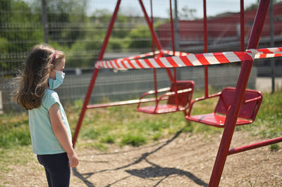 Side view of girl standing outdoors