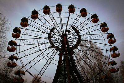 Low angle view of silhouette ferris wheel against sky