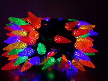 Close-up of illuminated christmas lights against black background