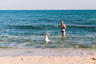 Full length of a young man swimming in sea