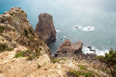 High angle view of rocks on sea shore