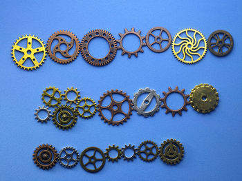 Close-up of gears on blue table