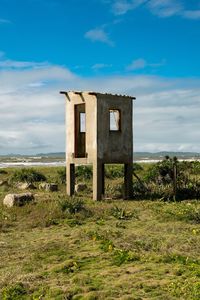 Built structure on field against sky