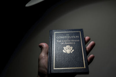 Close-up of hand holding us constitution