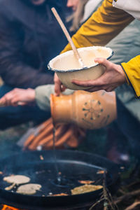 Cooking blini, blin or blynai, pancakes traditional sweet food, preparing outdoor on an open fire