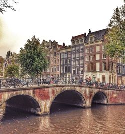 Bridge over river with buildings in background