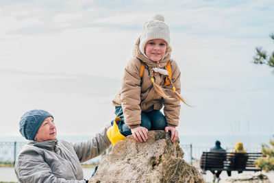 Grandmother and granddaughter go in for sports on stones in the open air to maintain health