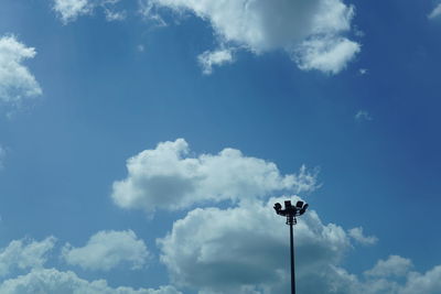 Low angle view of street light against blue sky