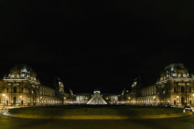 Illuminated city against sky at night