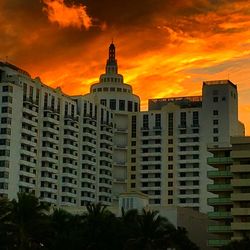 Low angle view of buildings against sky at sunset