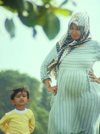 Full length of mother and daughter standing outdoors