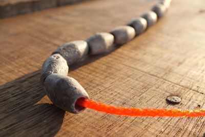 Close-up of beads in rope on table