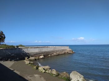 Scenic view of sea against blue sky