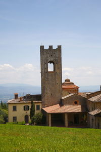 Historic building on field against sky