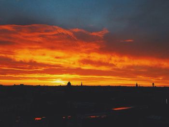 Silhouette of tree against dramatic sky