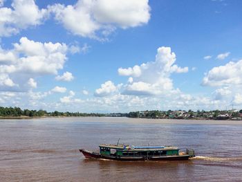 Boat in river against sky